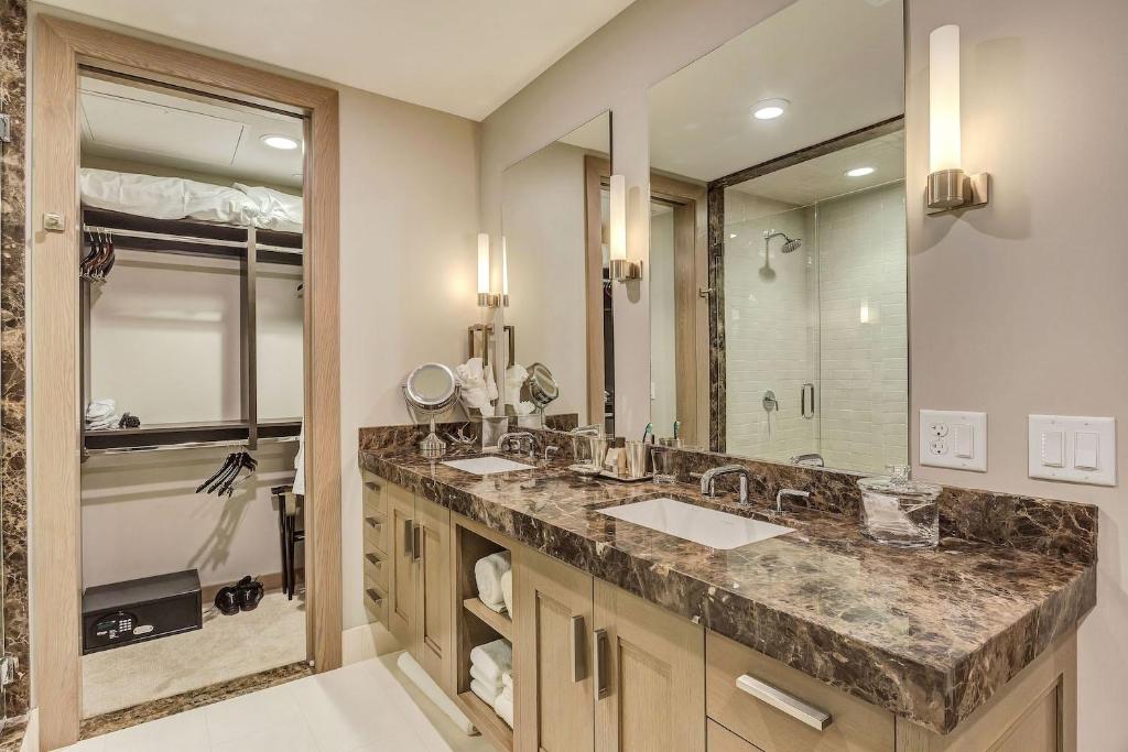 a bathroom with two sinks and a large mirror at Resort Room Hotel Room in Park City