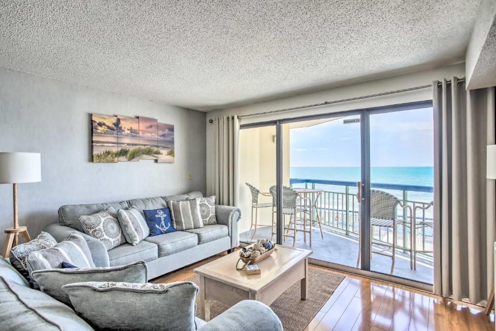 a living room with a couch and a view of the ocean at North Myrtle Beach Oceanfront Condo with Pool! in Myrtle Beach