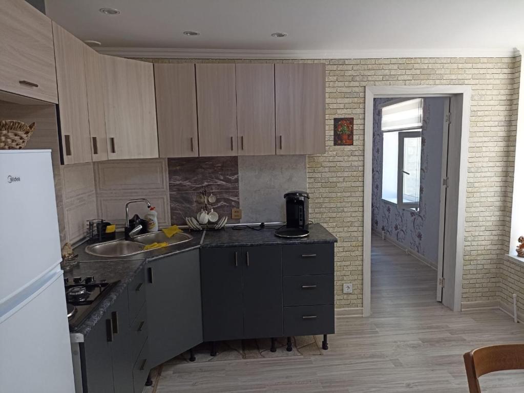 a kitchen with a sink and a counter top at Частный дом Ленкорань in Lankaran