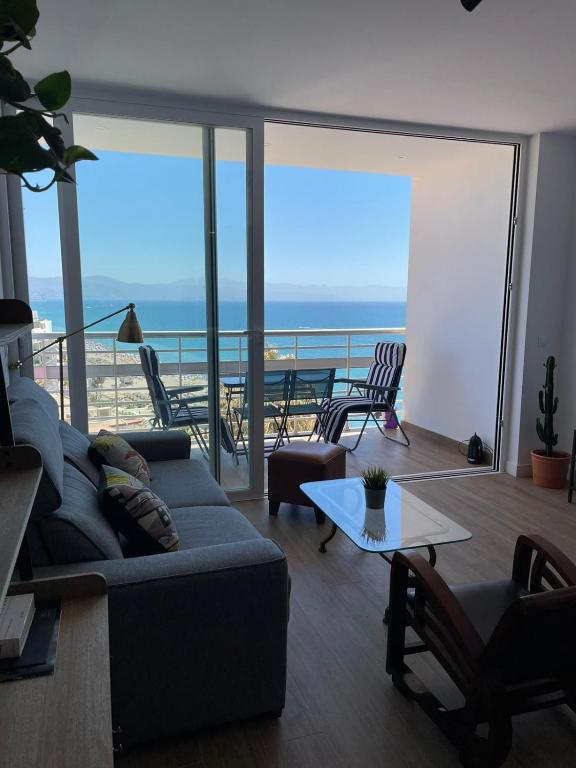 a living room with a couch and a view of the ocean at La Roca Sea View Apartment in Torremolinos