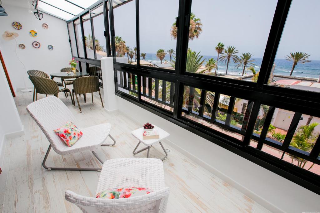a living room with a view of the beach at LUX Parque Santiago2 Las Americas First Line in Playa de las Americas