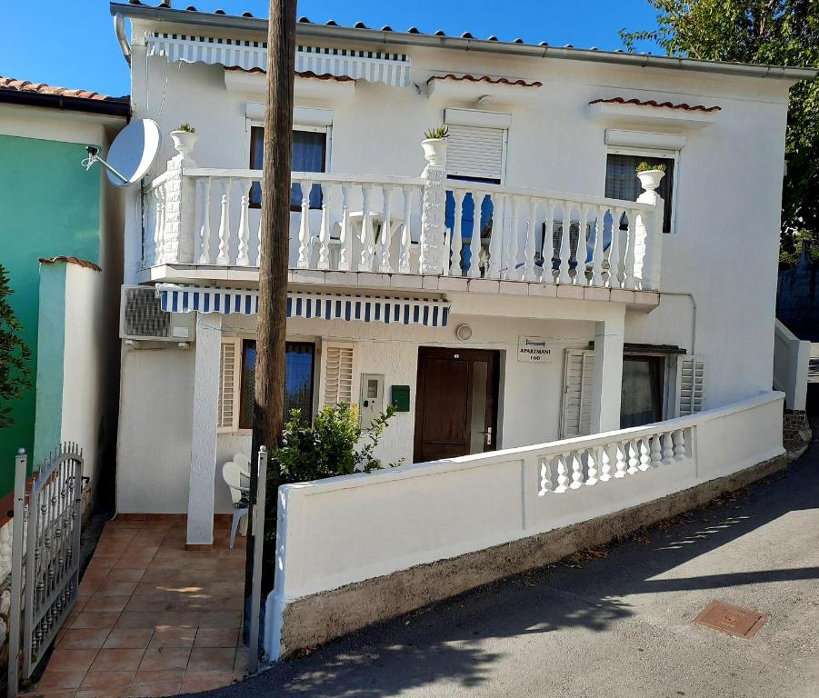 Casa bianca con balcone e veranda. di Apartmani Ana-Lora a Lopar