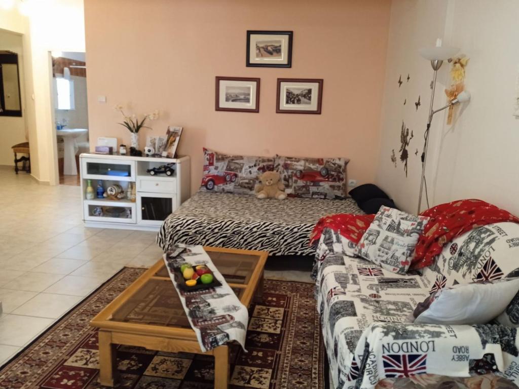 a living room with a couch and a table at Sweet Home in Volos