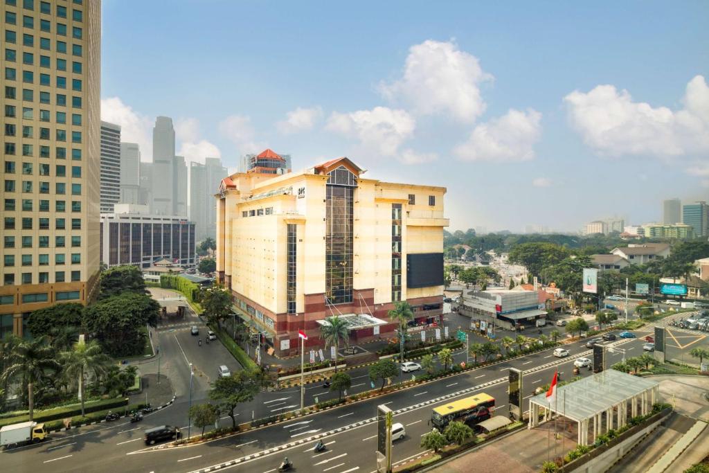 a city with a building and a street with traffic at Best Western Senayan in Jakarta