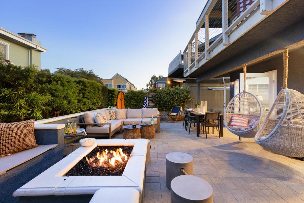 a patio with a fire pit on a house at Mission Point 1 by AvantStay San Diego Beach House w Huge Patio Fire Pit Walk to Beach in San Diego