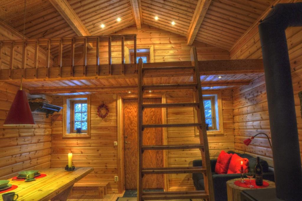 uma cama alta numa pequena casa em Cottage On Wild River In Lapland/Sweden em Karlsten