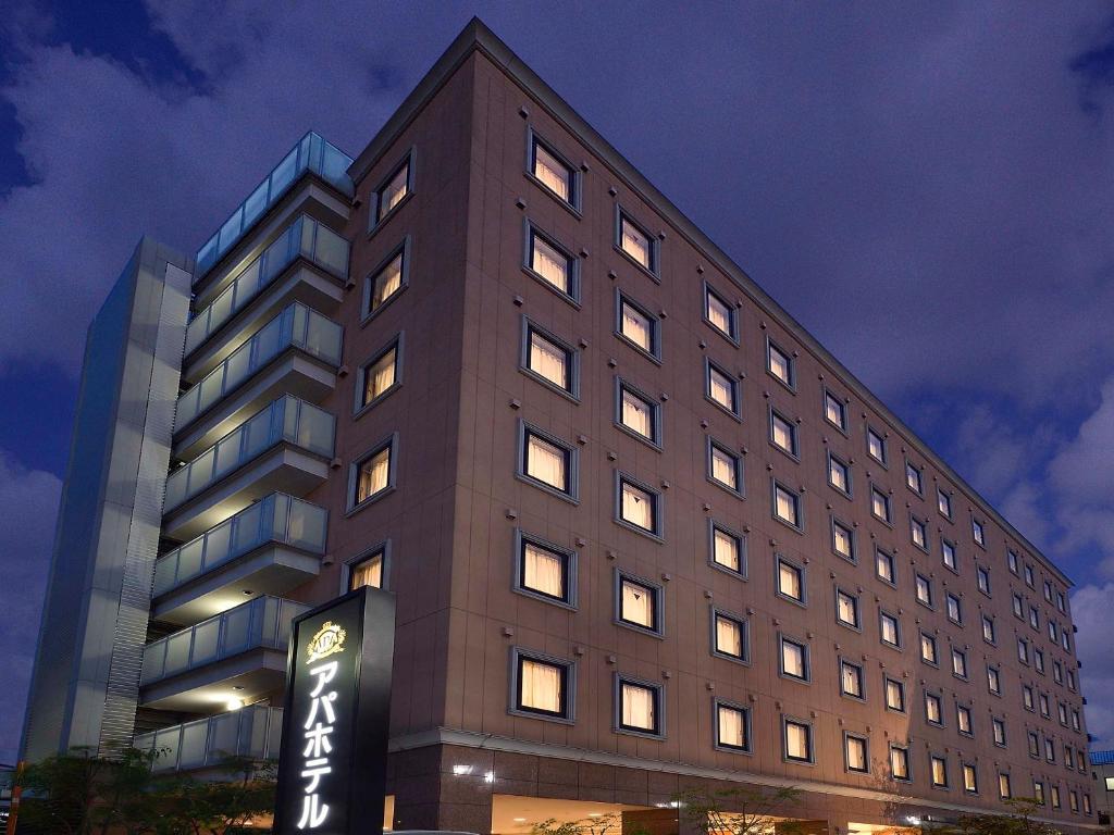 a tall building with a sign in front of it at APA Hotel Haneda Anamori Inari Ekimae in Tokyo