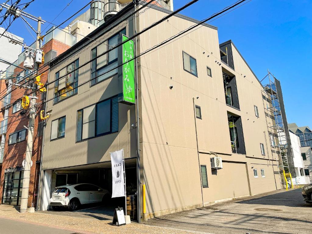 a building with a car parked in front of it at 和みの宿　おりがみ in Nagasaki