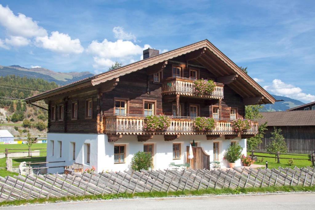 una casa de madera con una valla delante en Neuhaushof, en Hollersbach im Pinzgau