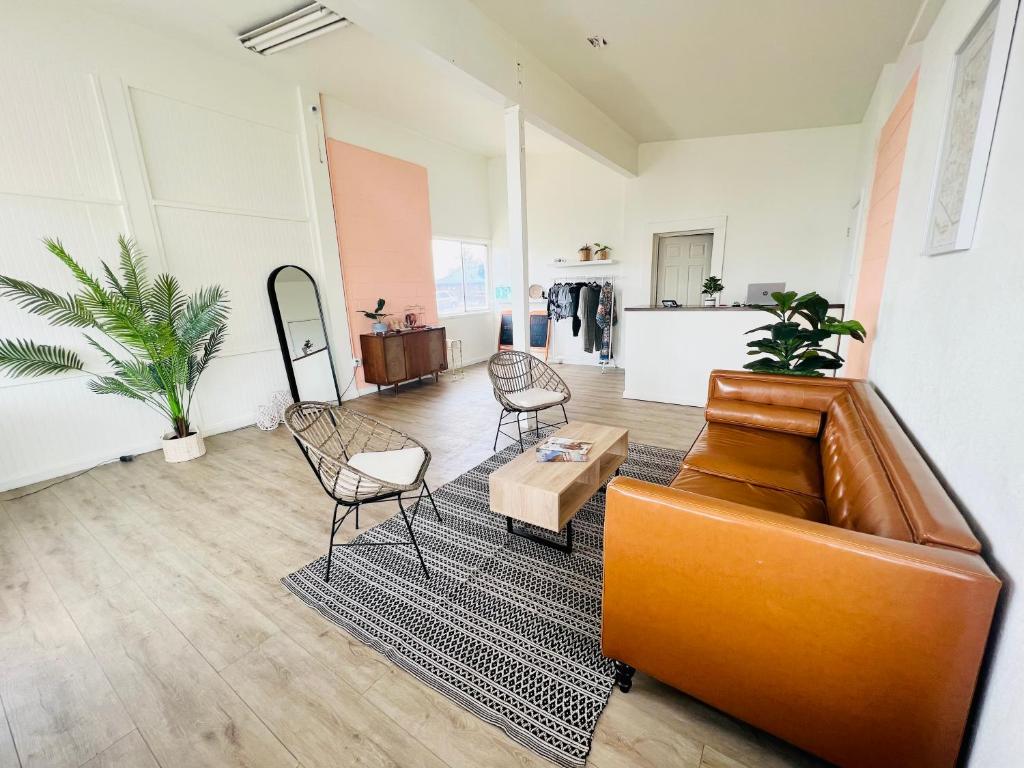 a living room with a couch and chairs at The Postcard Motel in Seligman