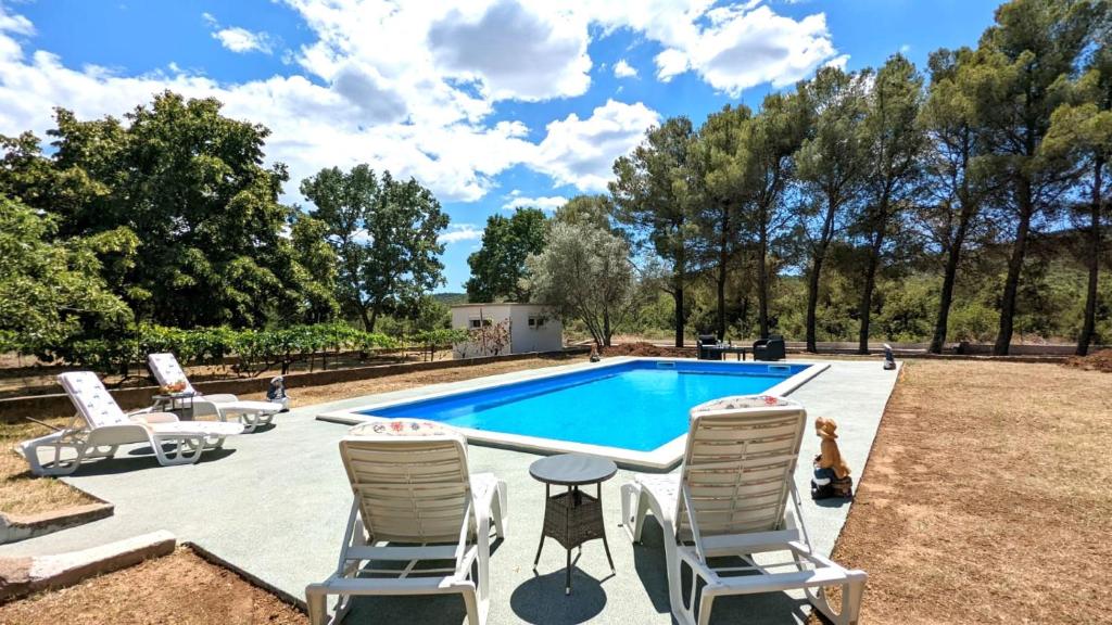 a swimming pool with lounge chairs and a table at Holiday Home Jaga in Biograd na Moru