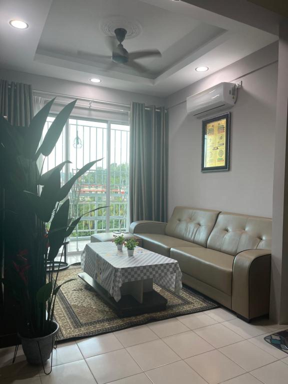 a living room with a couch and a table at MAYEA Homestay in Sandakan