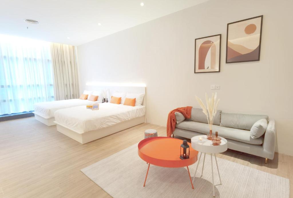 a living room with a bed and a couch at The Peak - Bangsar South Mid Valley in Kuala Lumpur