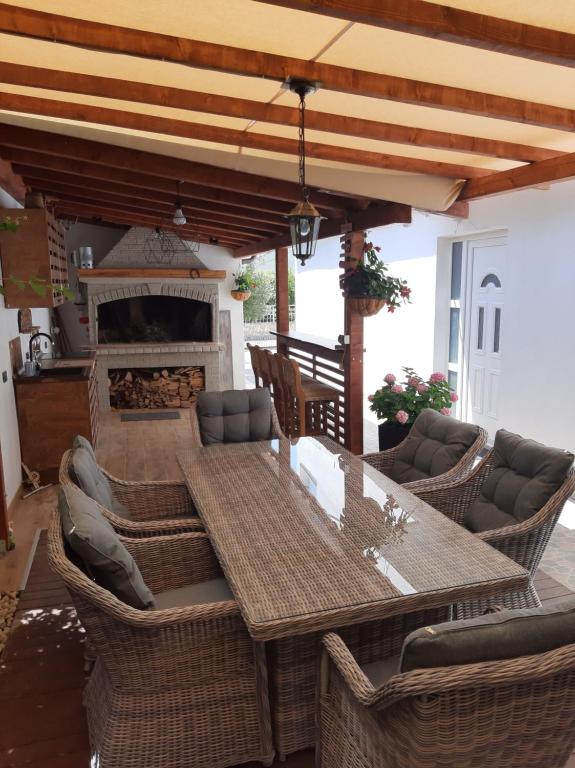 a patio with a table and chairs and a fireplace at Apartments Adria in Jadrija