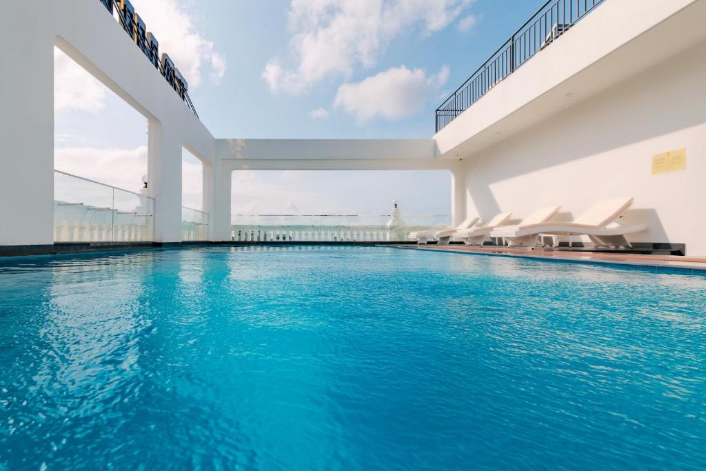 a swimming pool in a building with blue water at The Tahiti Beach Hotel in Phu Quoc