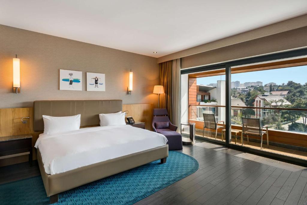 a hotel room with a bed and a large window at Radisson Blu Hotel & Spa, Istanbul Tuzla in Istanbul