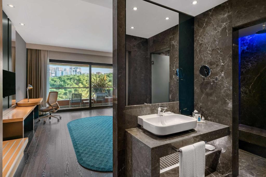 a bathroom with a sink and a mirror at Radisson Blu Hotel & Spa, Istanbul Tuzla in Istanbul