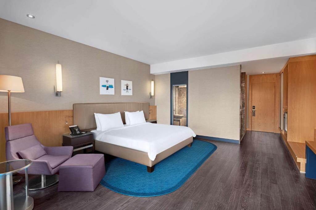 a hotel room with a bed and a chair at Radisson Blu Hotel & Spa, Istanbul Tuzla in Istanbul