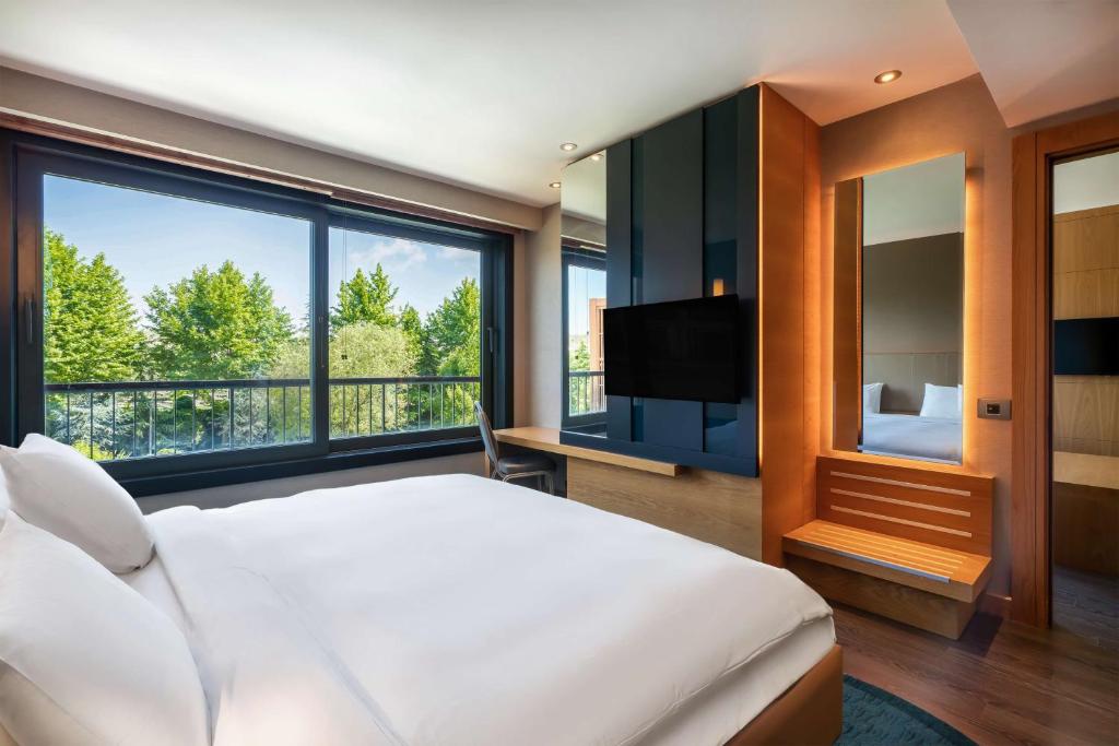 a bedroom with a bed and a large window at Radisson Blu Hotel & Spa, Istanbul Tuzla in Istanbul