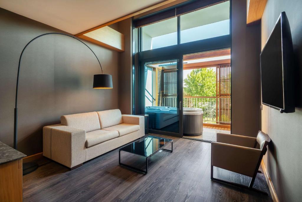 a living room with a couch and a table at Radisson Blu Hotel & Spa, Istanbul Tuzla in Istanbul