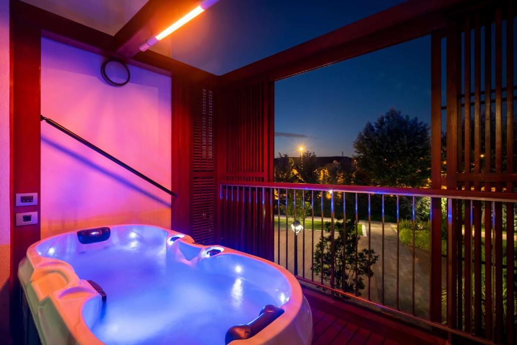 a room with a tub on a balcony with a view at Radisson Blu Hotel & Spa, Istanbul Tuzla in Istanbul