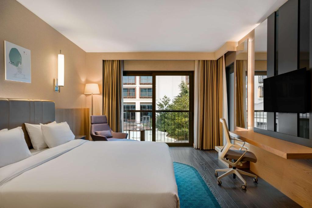 a hotel room with a large bed and a window at Radisson Blu Hotel & Spa, Istanbul Tuzla in Istanbul