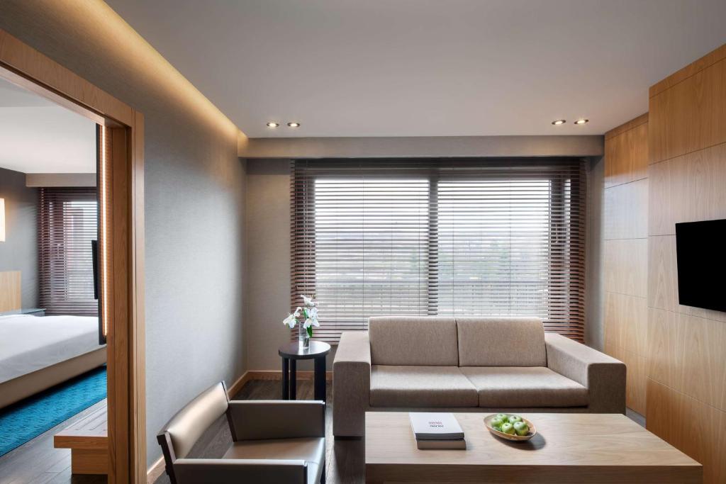 a living room with a couch and a bed at Radisson Blu Hotel & Spa, Istanbul Tuzla in Istanbul