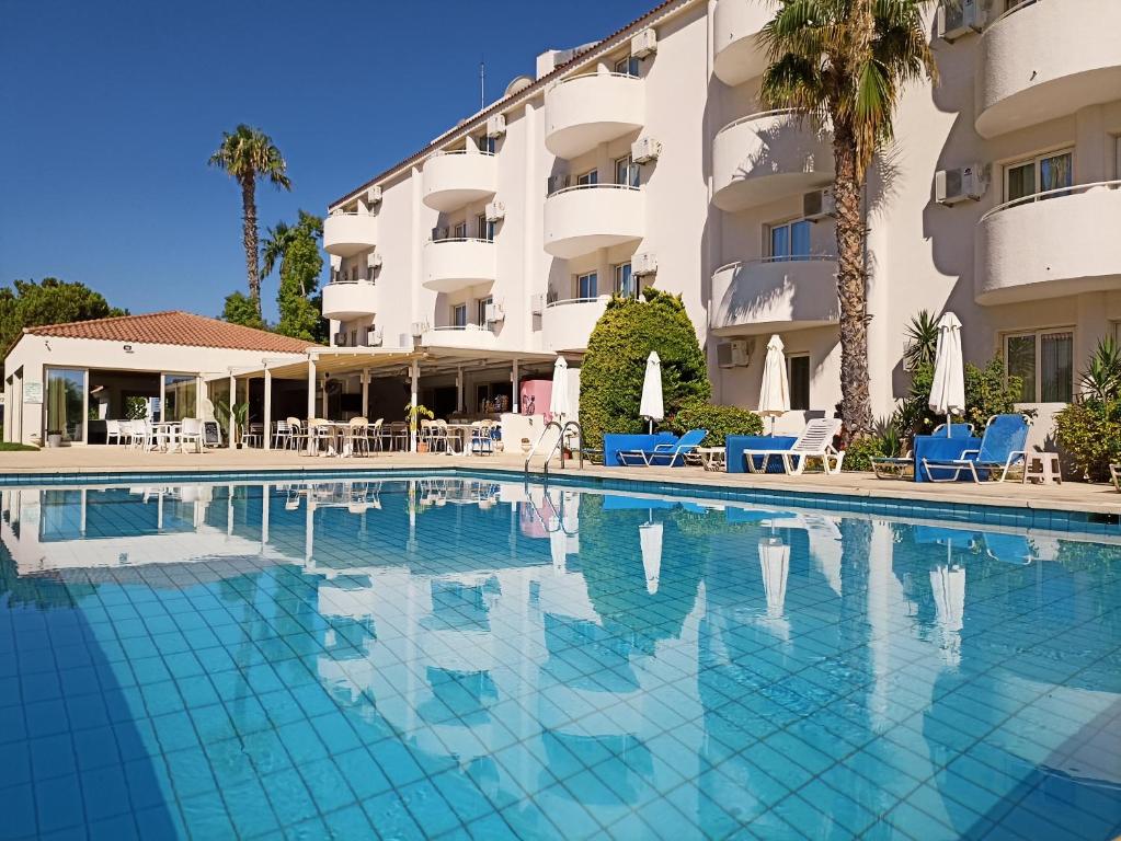 a swimming pool in front of a hotel at Mandalena Hotel Apartments in Protaras