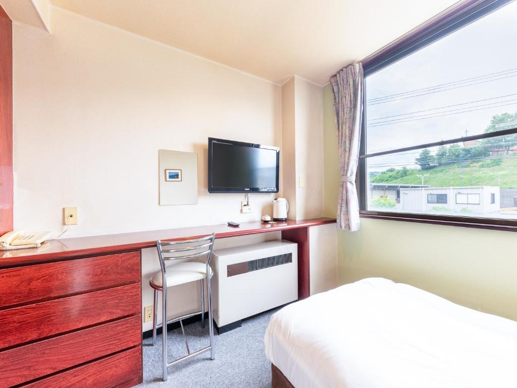 TV a/nebo společenská místnost v ubytování Tabist Travel Inn Shinshu Nakano