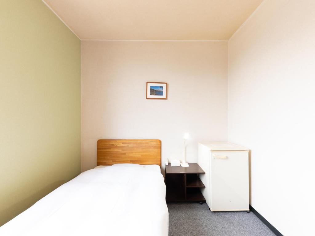 Postel nebo postele na pokoji v ubytování Tabist Travel Inn Shinshu Nakano