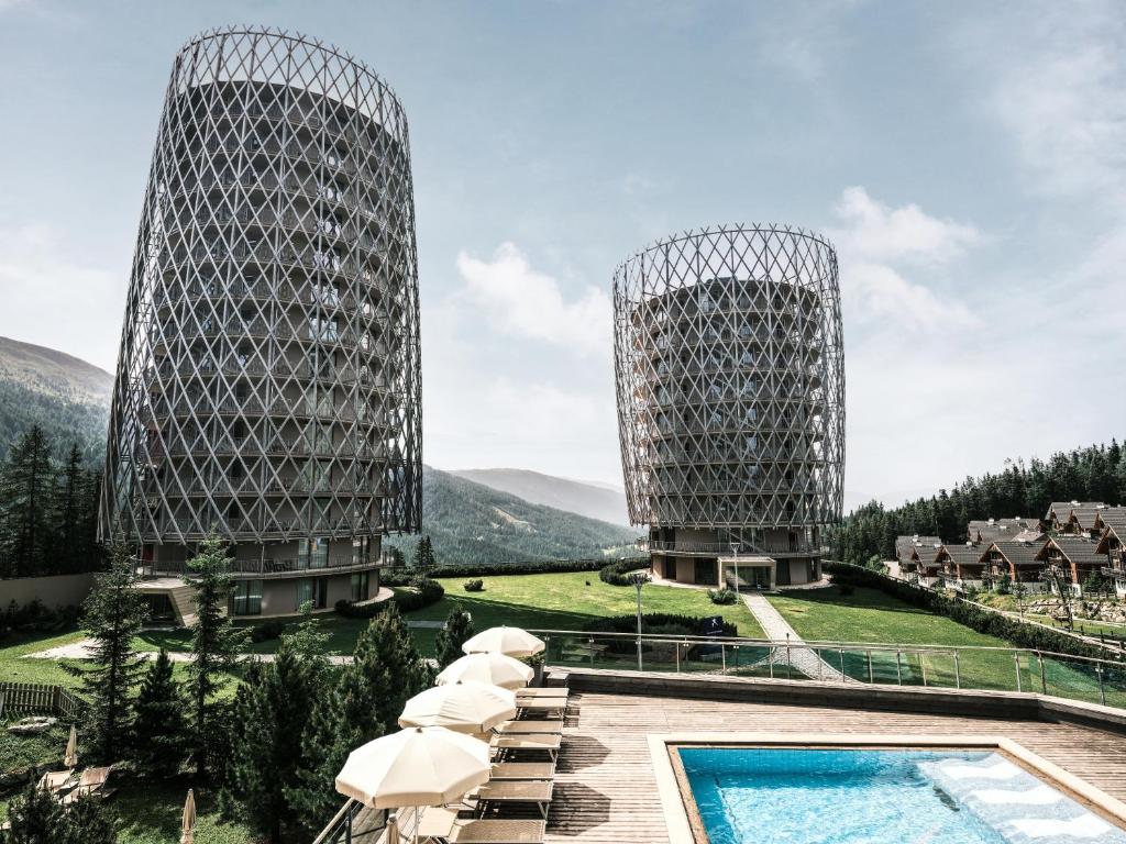 two towers with a swimming pool at a resort at Falkensteiner Residences edelweiss in Katschberghöhe