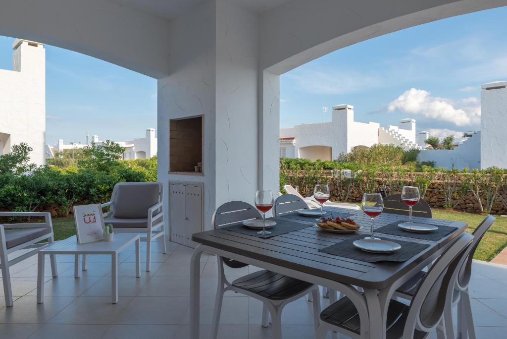 a table with glasses of wine on a patio at Blue Sea Villas by Wonderful Italy in Ostuni