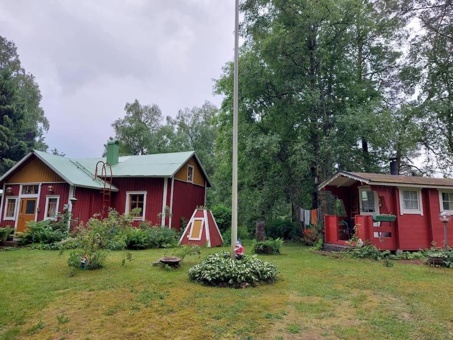 a house with a tent in the yard next to it at Idyllinen mökki Laitilassa in Laitila