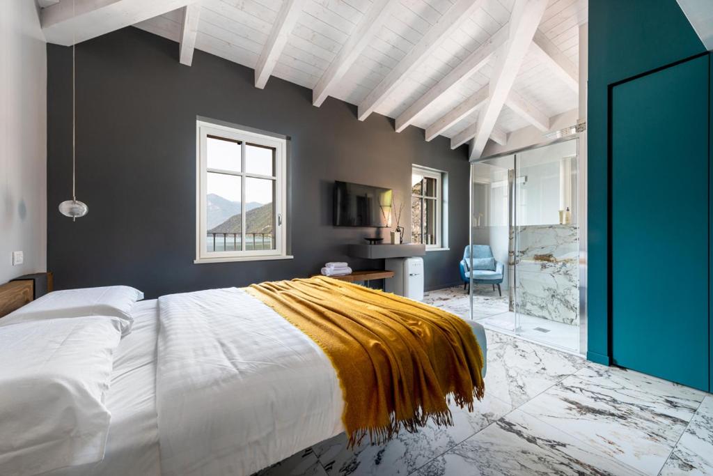 a bedroom with a large bed with a yellow blanket on it at Vulcano Palace in Castro