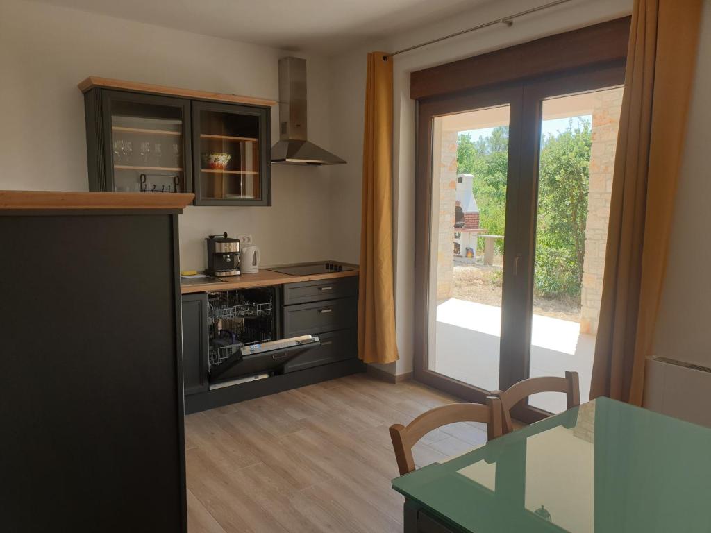 uma cozinha com uma porta aberta para um pátio em Villa Istra em Divšići