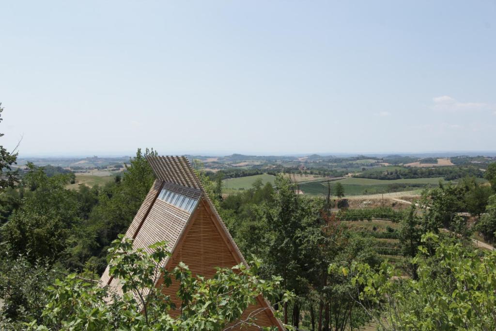a house on top of a hill with trees at LILELO - Little Leisure Lodge in Grazzano Badoglio