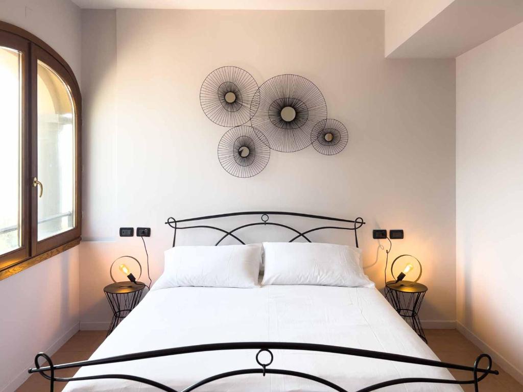 a bedroom with a bed with two mirrors on the wall at Sensole locanda contemporanea in Monte Isola