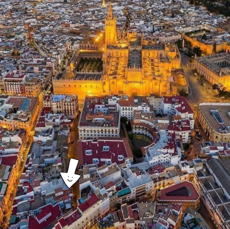 an aerial view of a city with a white arrow at Piso a 60 metros de la Catedral in Seville