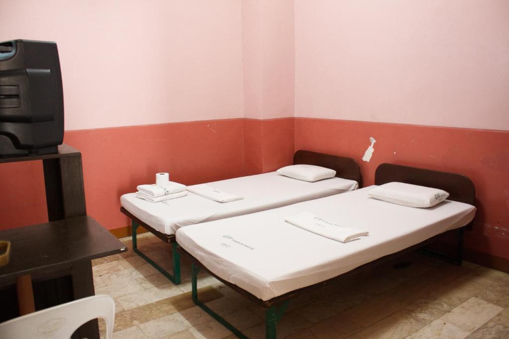 Postel nebo postele na pokoji v ubytování GV Hotel - Baybay