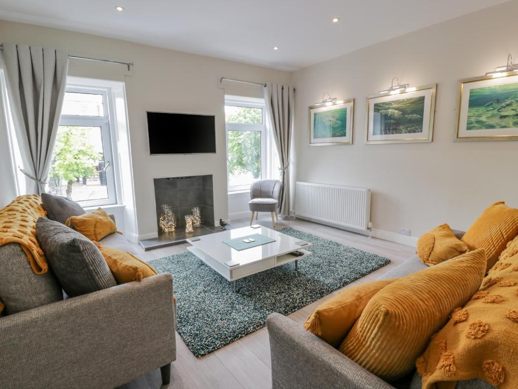 a living room with two couches and a fireplace at 1 Syme Street in Moffat