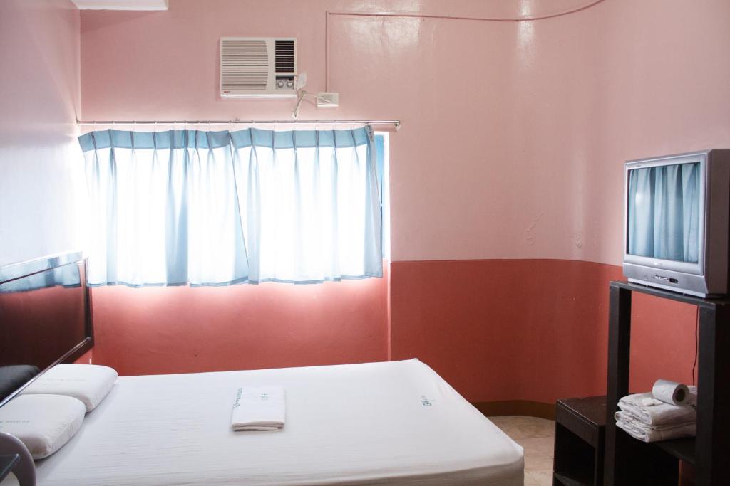 Postel nebo postele na pokoji v ubytování GV Hotel - Baybay