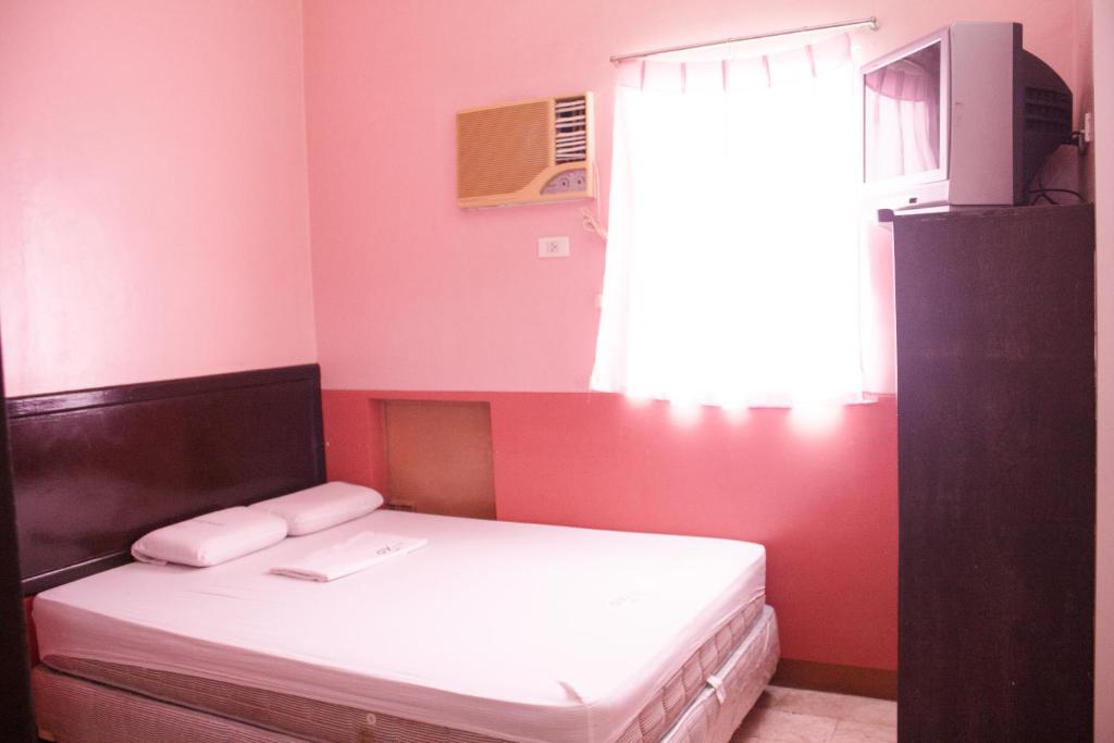 Postel nebo postele na pokoji v ubytování GV Hotel - Baybay