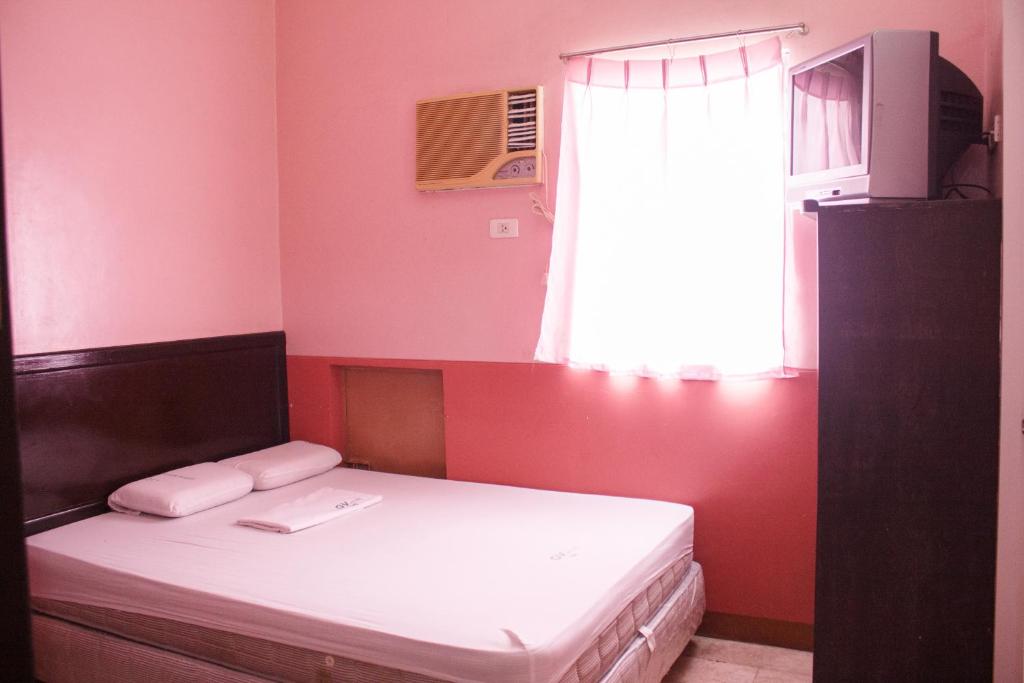 Postel nebo postele na pokoji v ubytování GV Hotel - Baybay