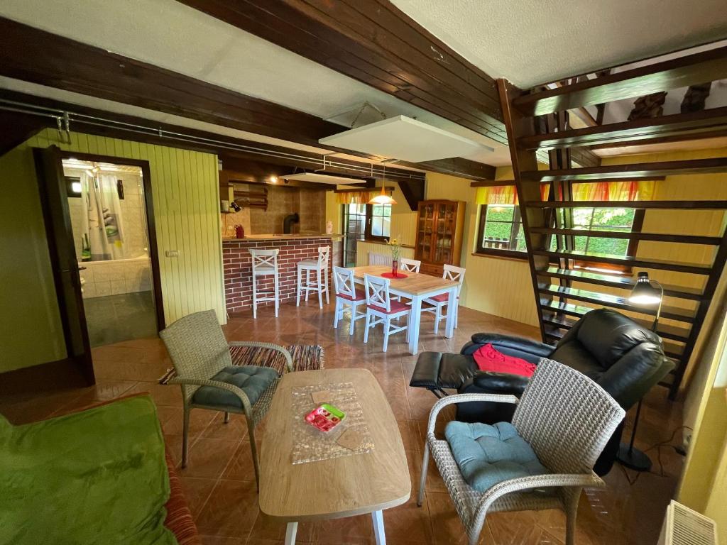 a living room with a table and chairs and a kitchen at Mr. Bens cottage in Škofja Loka