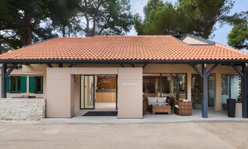 a pavilion with a roof on top of a building at Apartments Bellevue Plava Laguna in Poreč