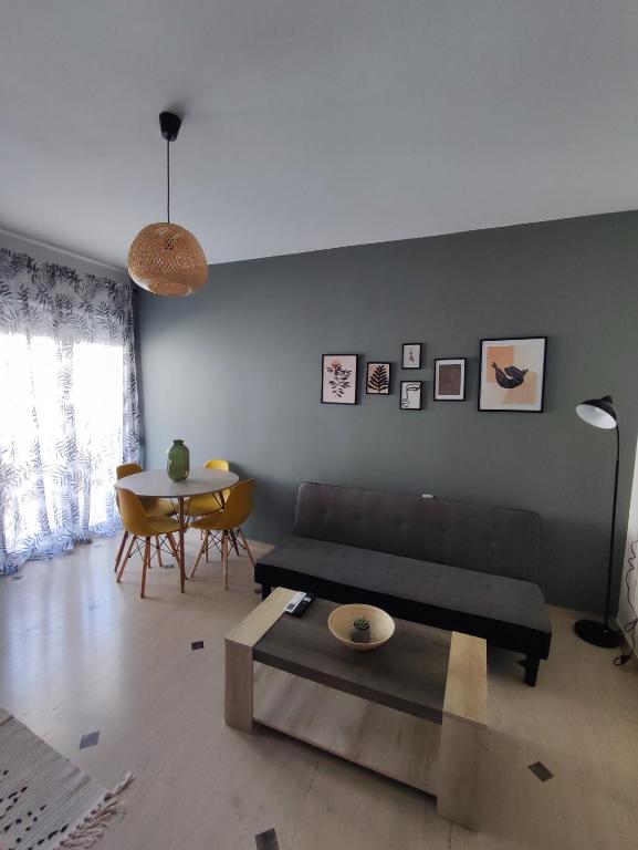 a living room with a couch and a table at EM.MA HOME in Heraklio