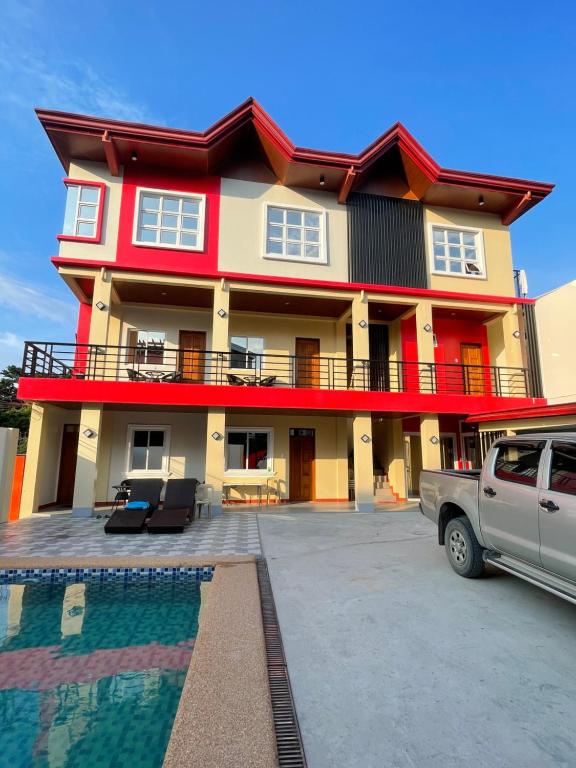 a house with a car parked in front of it at Jolly's suite in Puerto Galera
