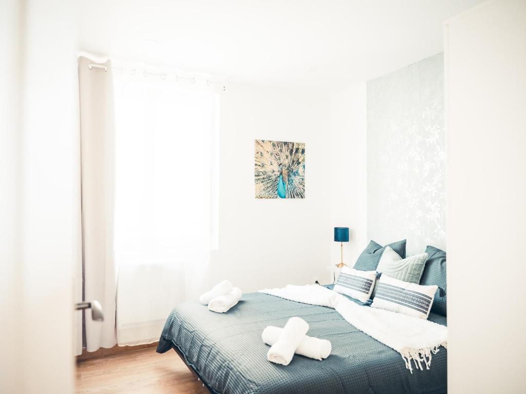 ein Schlafzimmer mit einem Bett mit zwei weißen Handtüchern darauf in der Unterkunft BLUE IVY Très beau F2 à 2 pas du port in Dunkerque