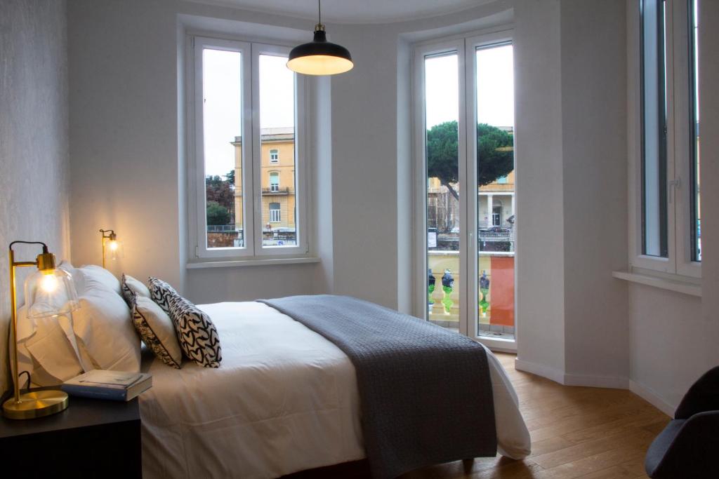 a bedroom with a bed with a view of a city at Palazzo Belli Roma in Rome