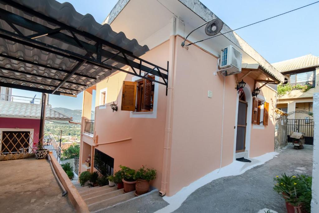 a view of a house with stairs and a balcony at Traditional village house in Ágios Matthaíos